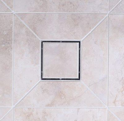 Example of tiling up to a square wet room floor drain