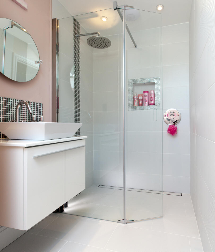 Image shows a typical wet room shower. Note the level access and glass wall dividing the shower area from the rest of the bathroom.