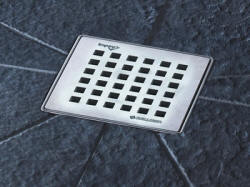 Aquadec 4 inch stainless steel waste outlet on a tiled floor